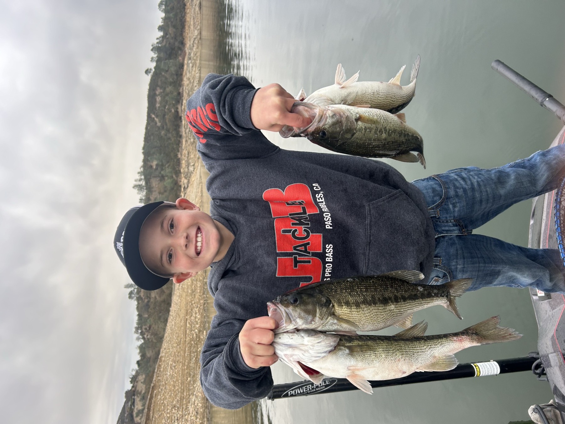 Young angler holding four bass caught on Lake Nacimiento