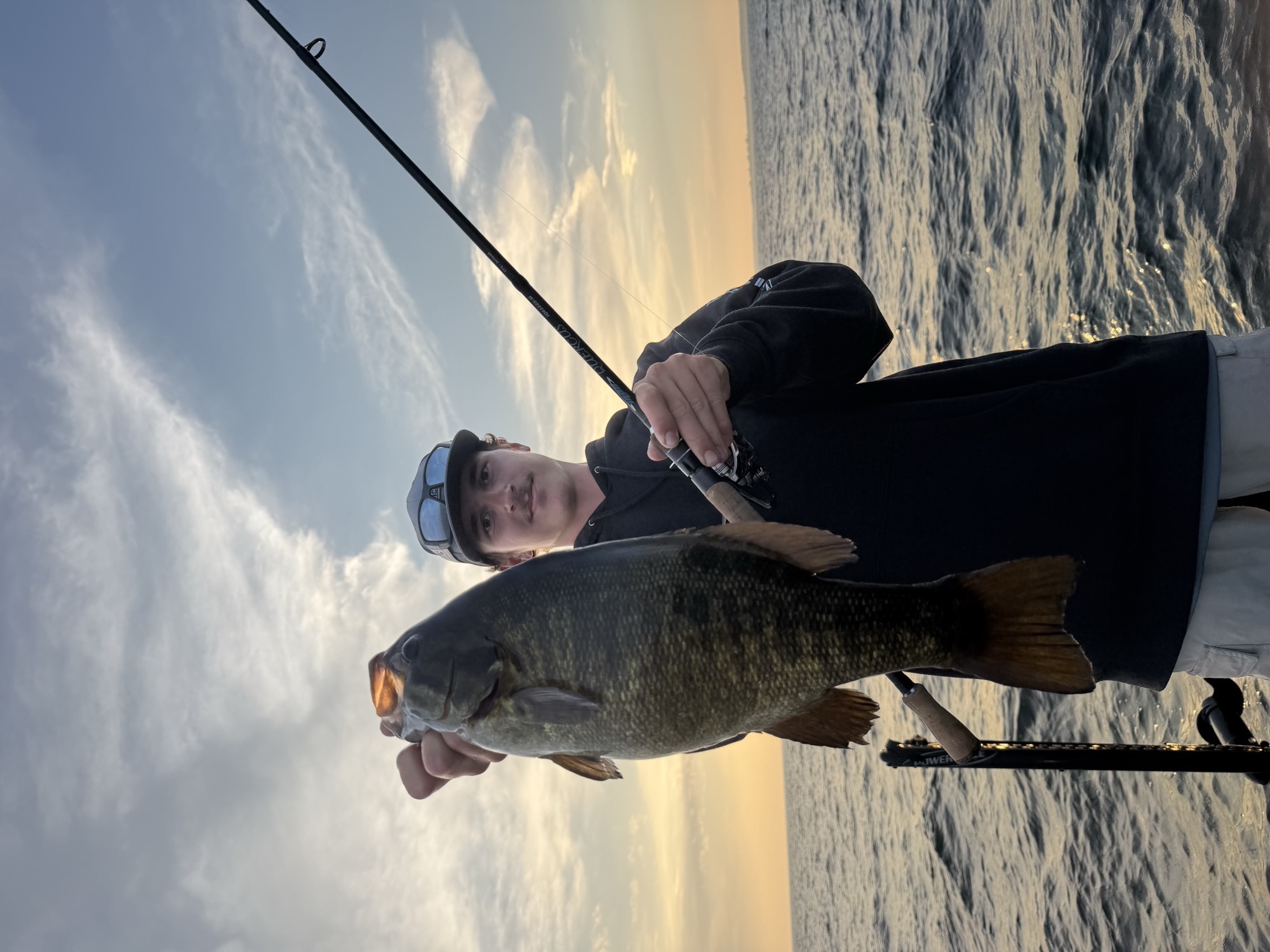 Angler holding a large bass at golden hour on Lake Nacimiento